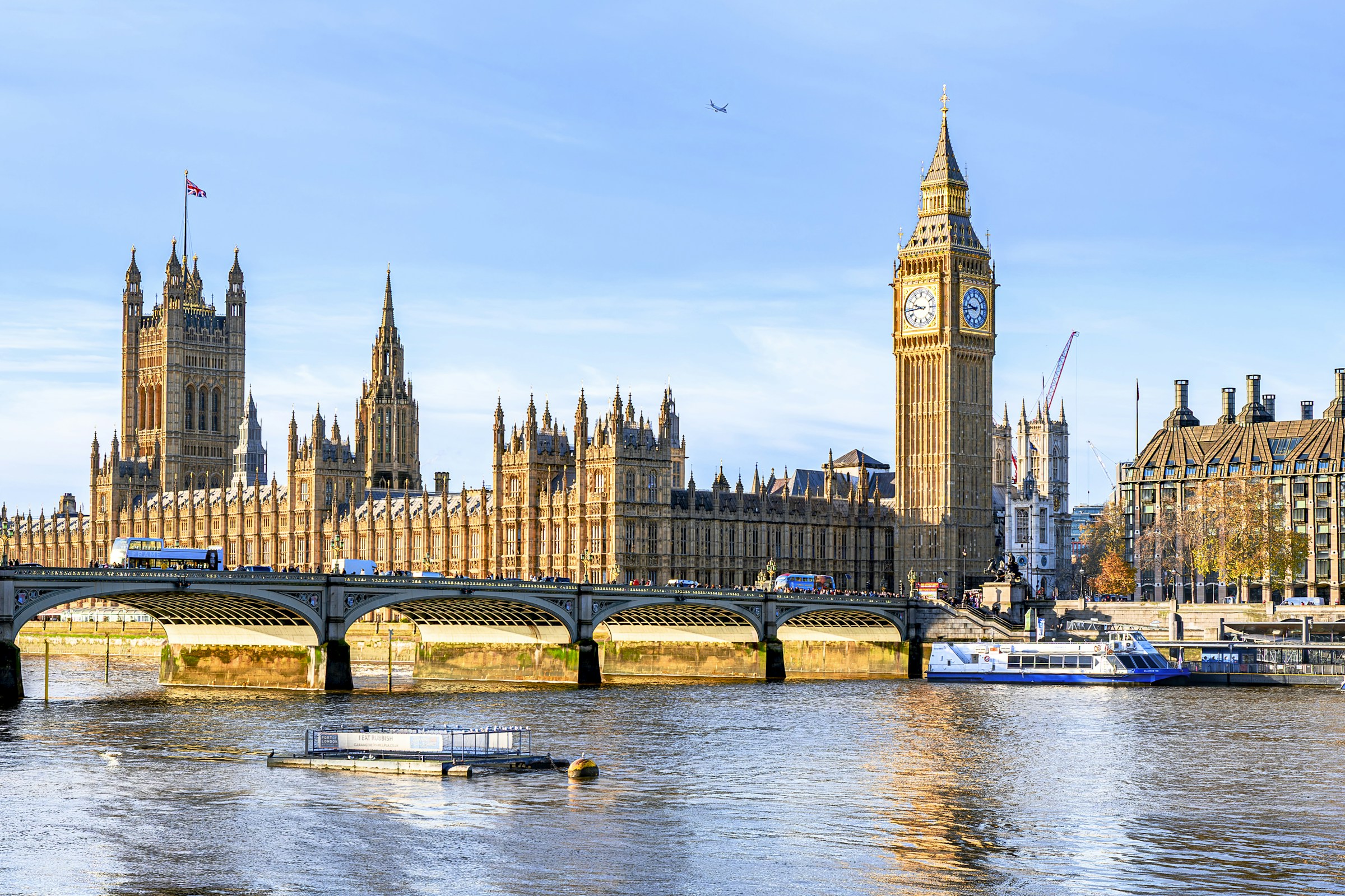 Sunlit Big Ben and the Palace of Westminster above the River Thames in London