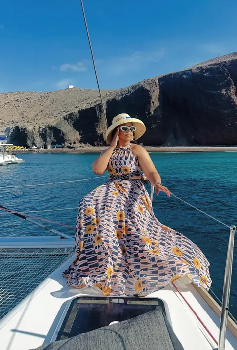 A sunlit catamaran journey along the volcanic coastline